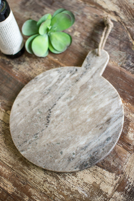 round grey marble cutting board with jute