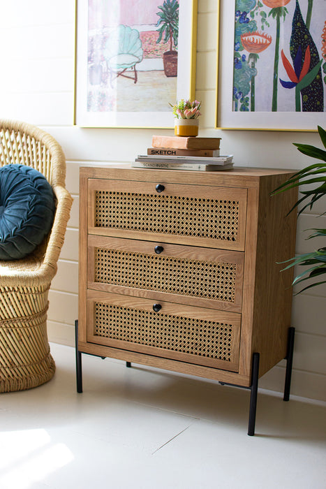 wooden bedside table with three woven cane drawers
